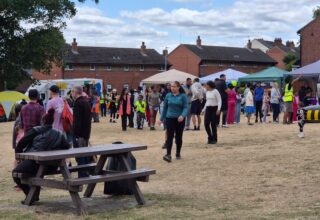 Photograph of people in a park at a community gala